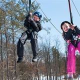 Kids ziplining in the winter.