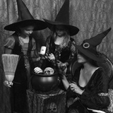People posing dressed as witches at Capone's Old Time Studio.