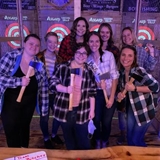 Group of friends throwing axes.