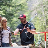 An instructor showing guests how to bowfish.