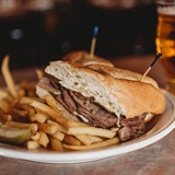 A sandwich, fries, and beer at Pizza Pub.