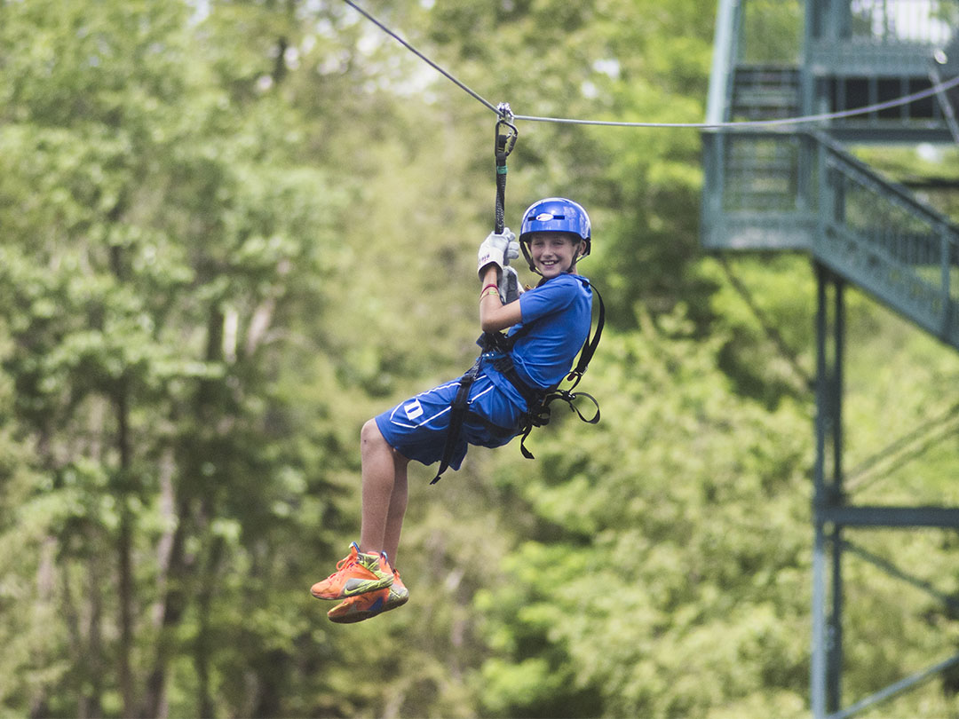 A boy ziplining at BigFoot Ziplines in Wisconsin Dells.