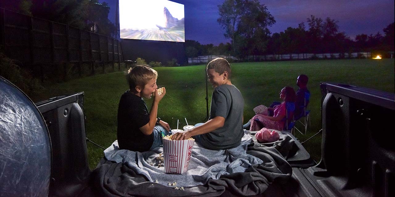 Two kids watching a movie at Big Sky drive in theater