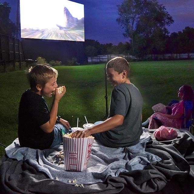 Kids eating snacks at a drive-in theater.