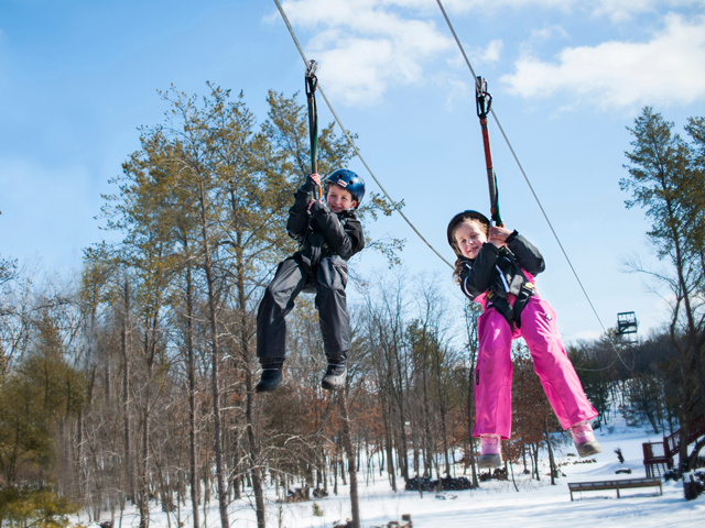 Kids ziplining at Bigfoot Ziplines in Wisconsin Dells.