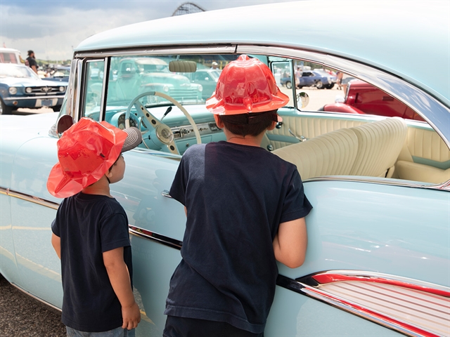 Kids looking at a car at Automotion Classic Car Show in Wisconsin Dells.
