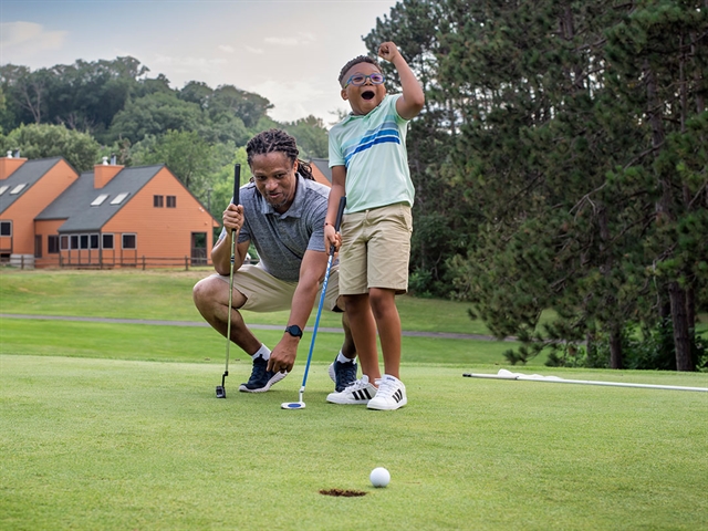 A family golfing at Christmas Mountain golf course in Wisconsin Dells.