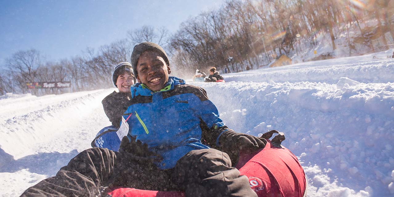 Two boys snow tubing at Cascade Mountain