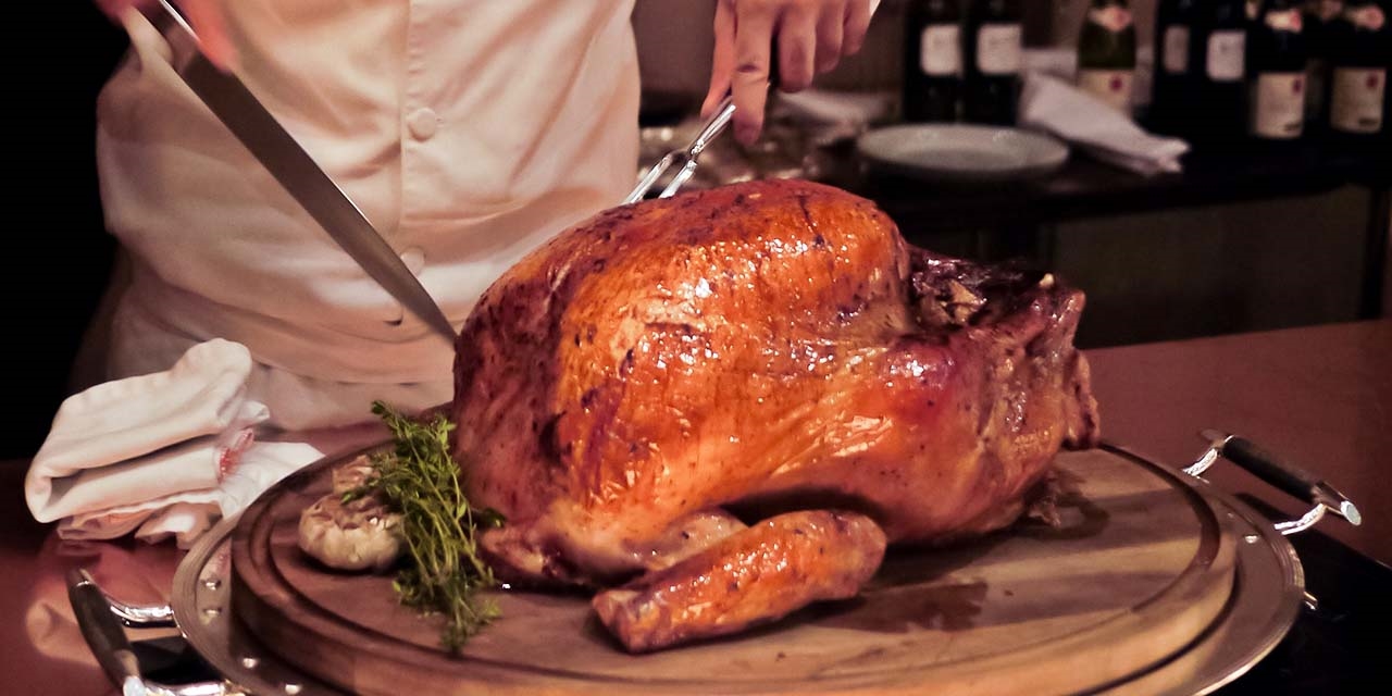 Chef cutting thanksgiving turkey