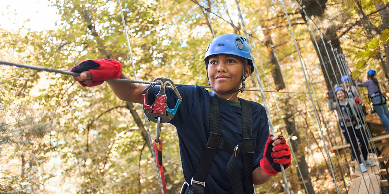 A boy on a high ropes course.