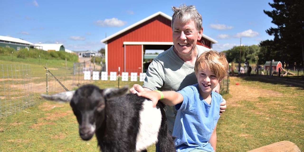 Boy and grandfather at Country Bumpkin Petting Zoo