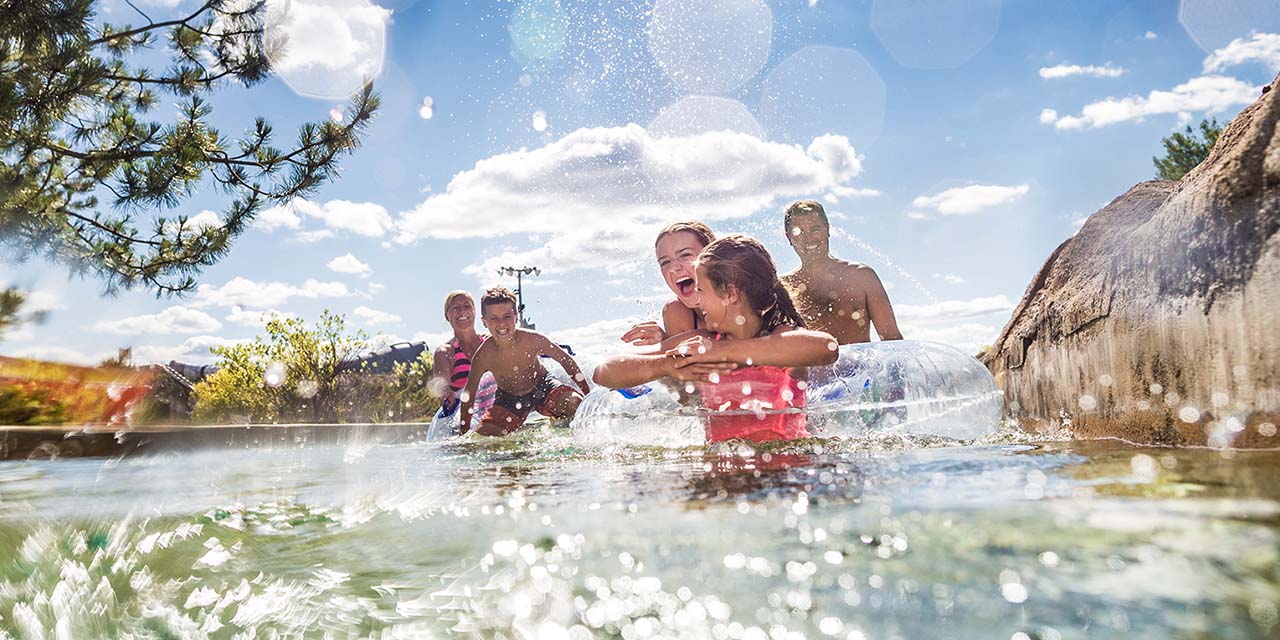 Family floating on Noah's Ark Waterpark's lazy river