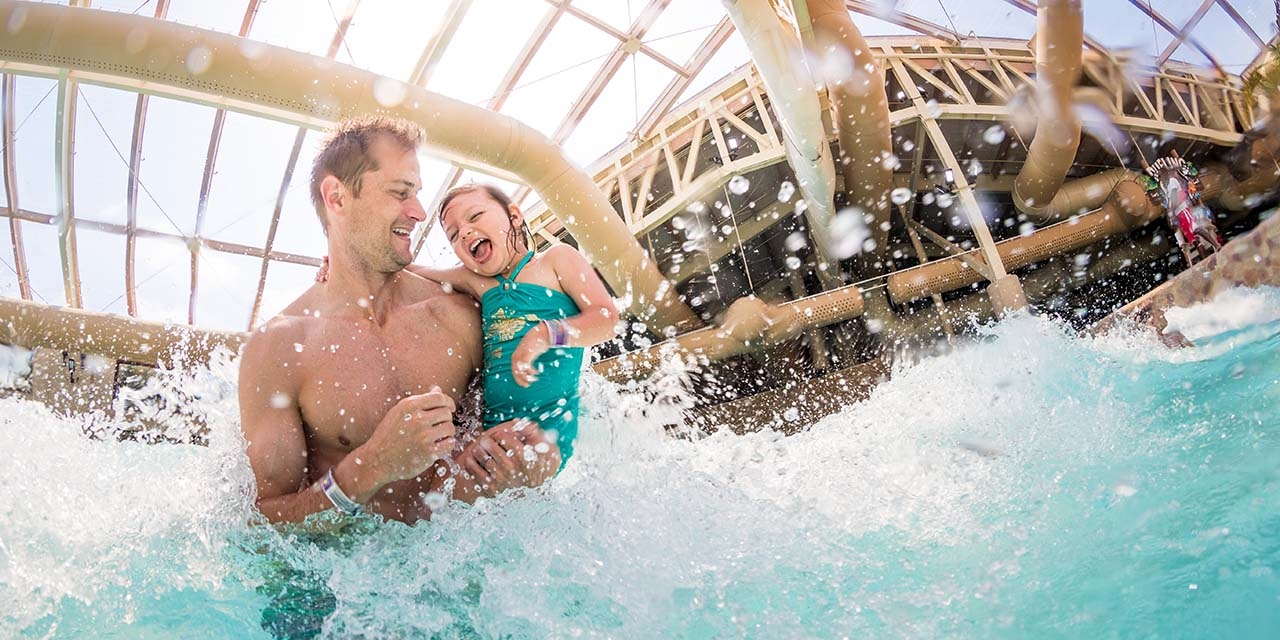 Father and daughter swimming at Wilderness Resort Waterpark wave pool