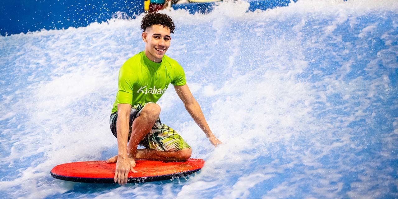 A boy riding a flowrider surf machine at Kalahari Waterpark