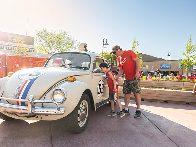 son and dad looking at herbie car