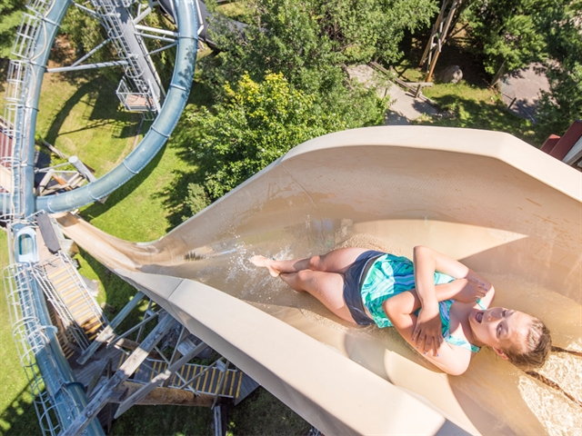 A girl going down a large waterslide at Noah's Ark Waterpark.