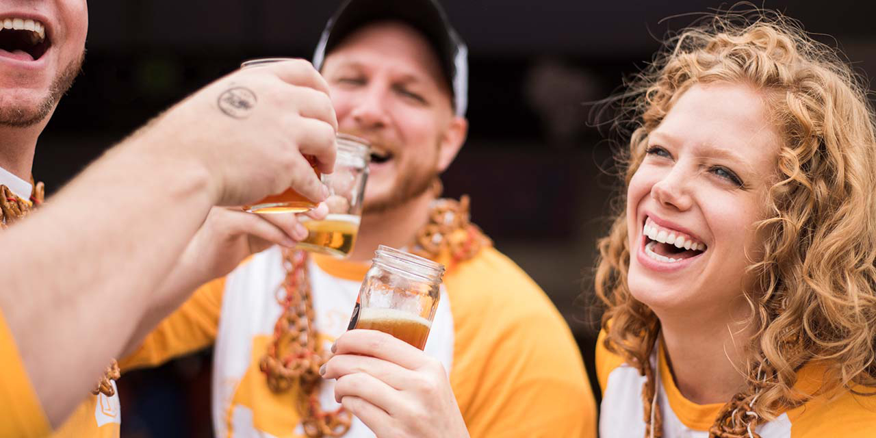 Girl drinking beer at Dells On Tap event