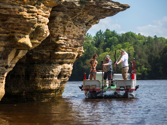 People bow fishing.