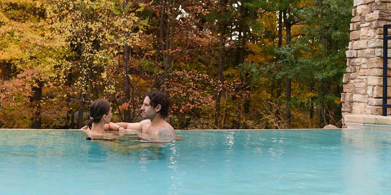 Couple in the infinity pool at Sundara Inn & Spa