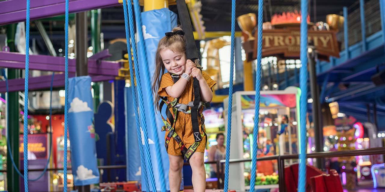 Girl doing ropes course at Tom Foolerys Adventure Park