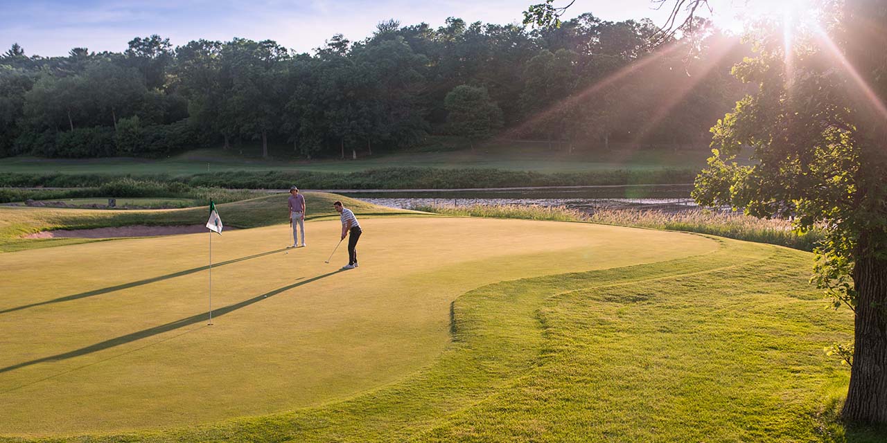 Men putting on the green at trappers turn golf course