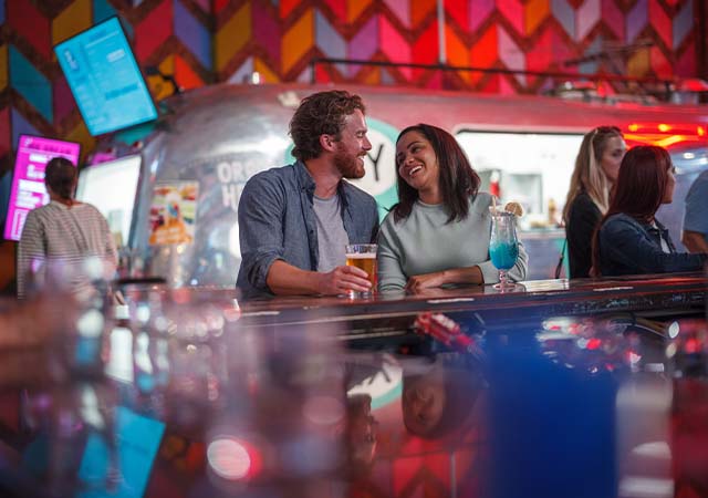 Couple enjoying cocktails at Grateful Shed