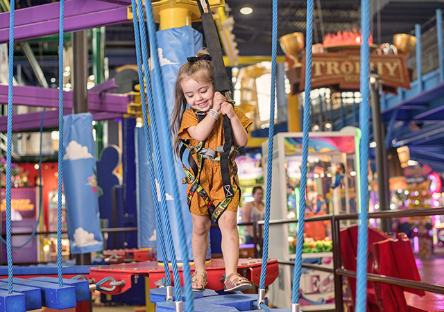 Girl playing on adventure park