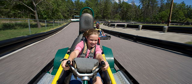 Girl smiling and driving a go-kart