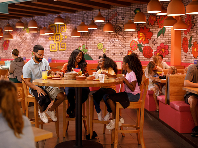 family sitting around table enjoying food