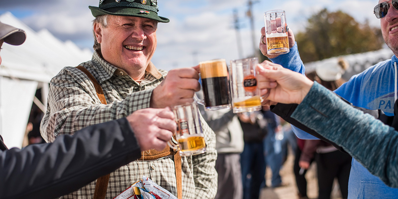 Men cheering at Dells On Tap event.