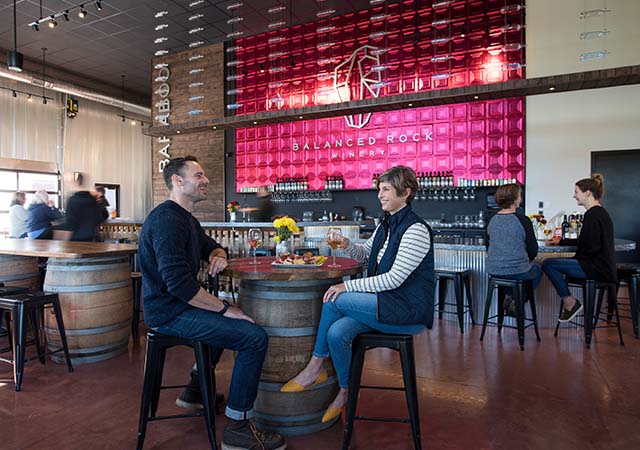 Two adults sitting at Balanced Rock Winery.