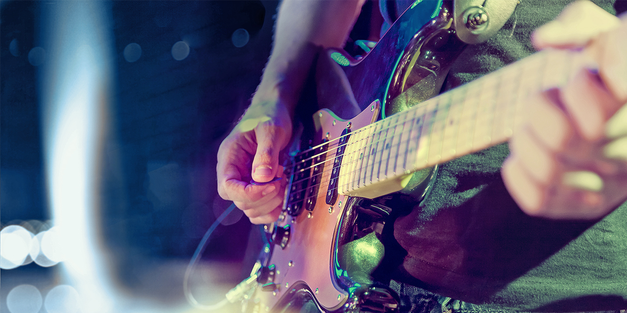 A person playing a guitar.