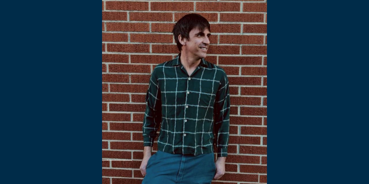 Kurt leaning against the wall