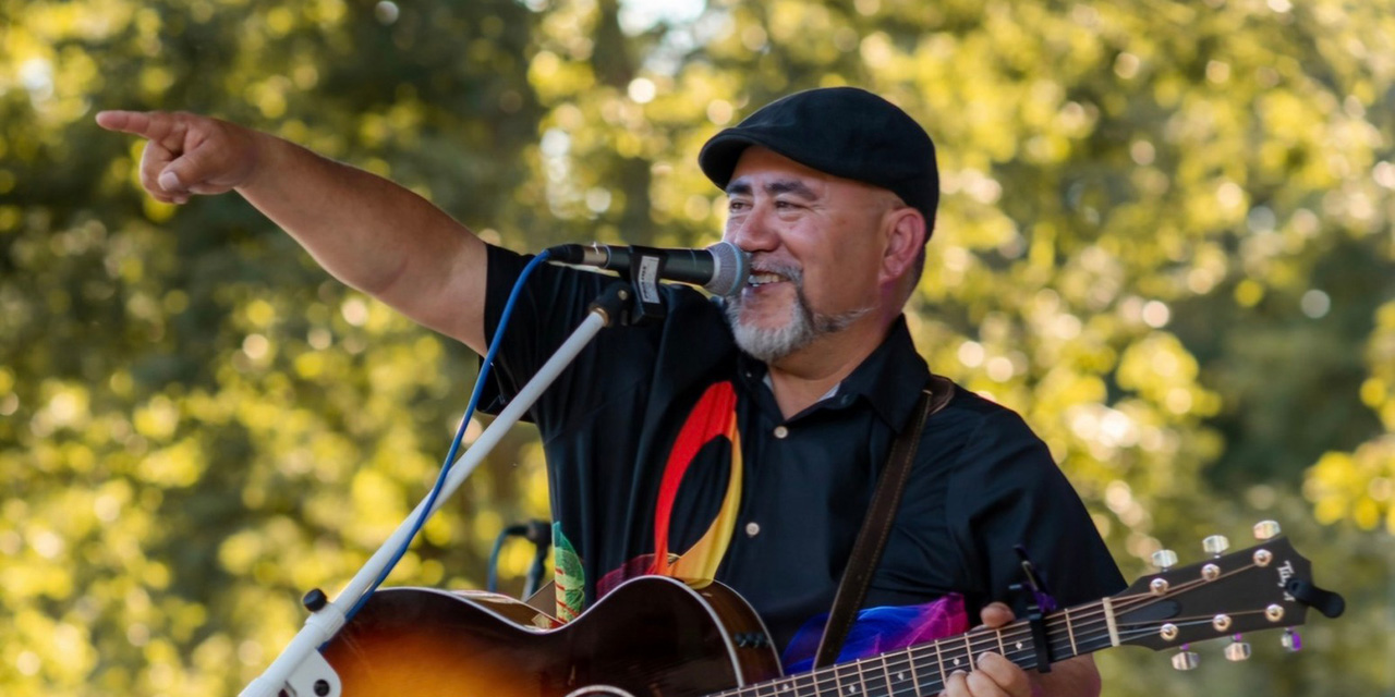 Gene Gruber singing and playing guitar