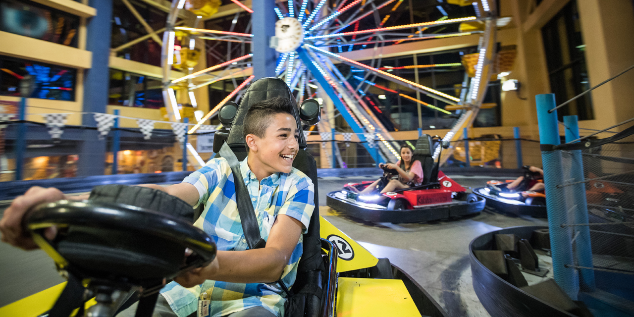 Kids racing on go karts at Tom Foolerys Adventure Park in Wisconsin Dells.