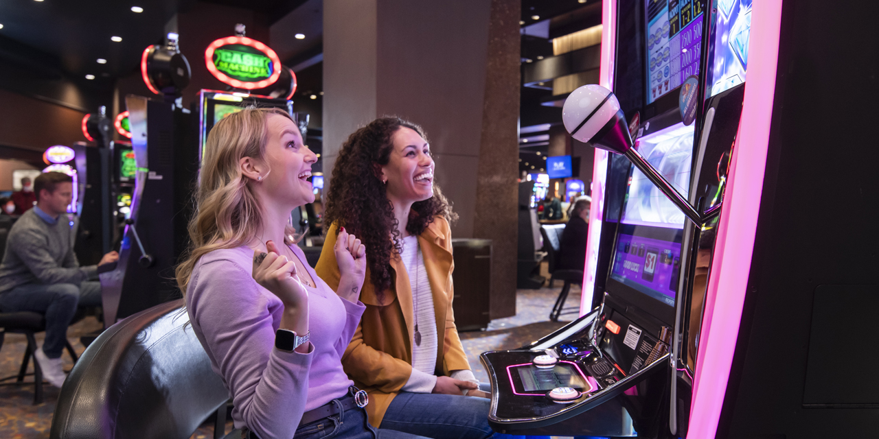 2 women using machines at Ho-Chunk Casino.