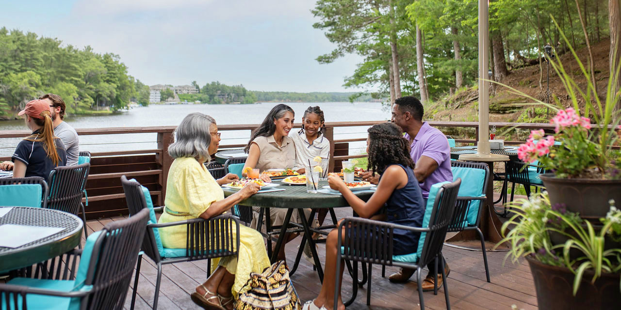 Family dining on a beautiful lakefront patio.