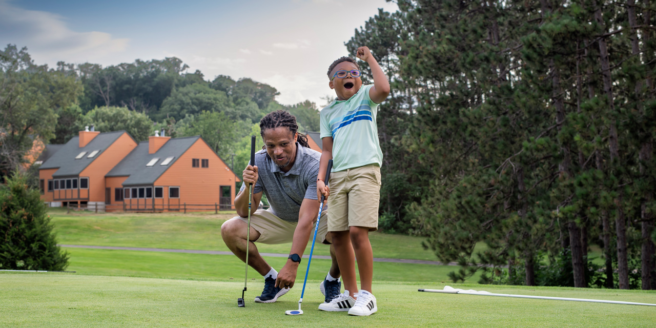 Father and son playing golf.