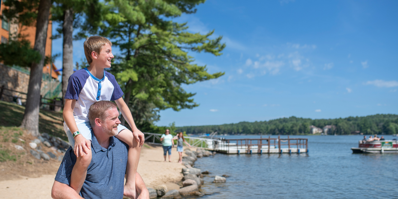Father and son on the beach at Lake Delton.