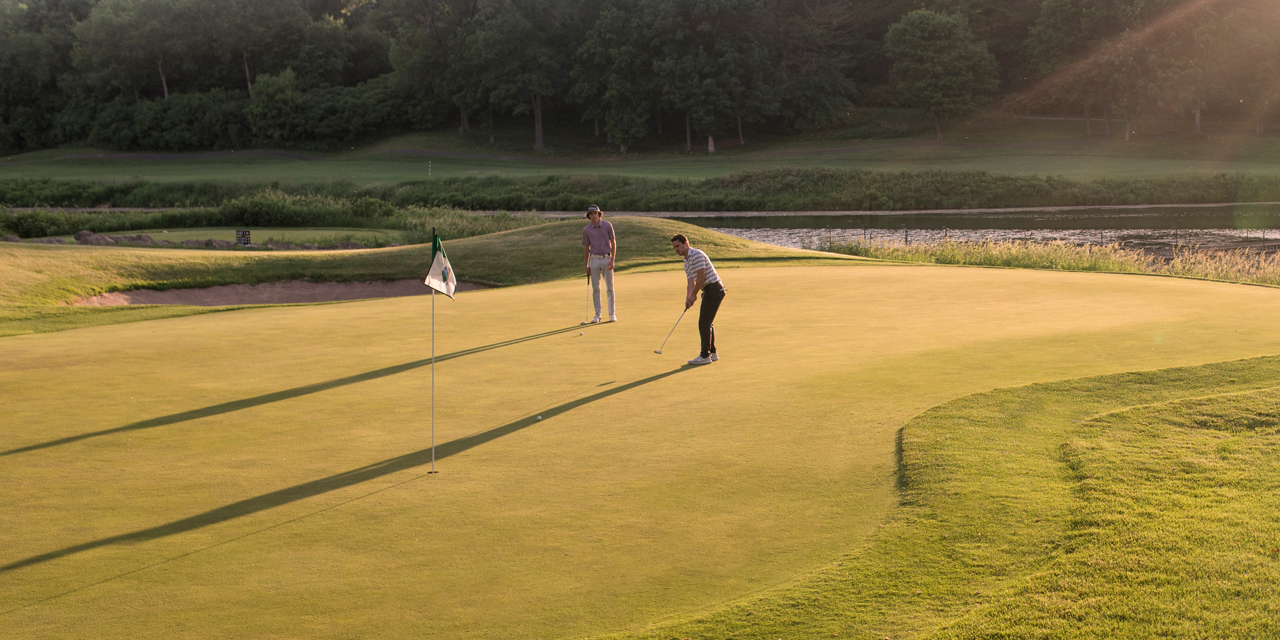 Two people playing golf in Wisconsin Dells.