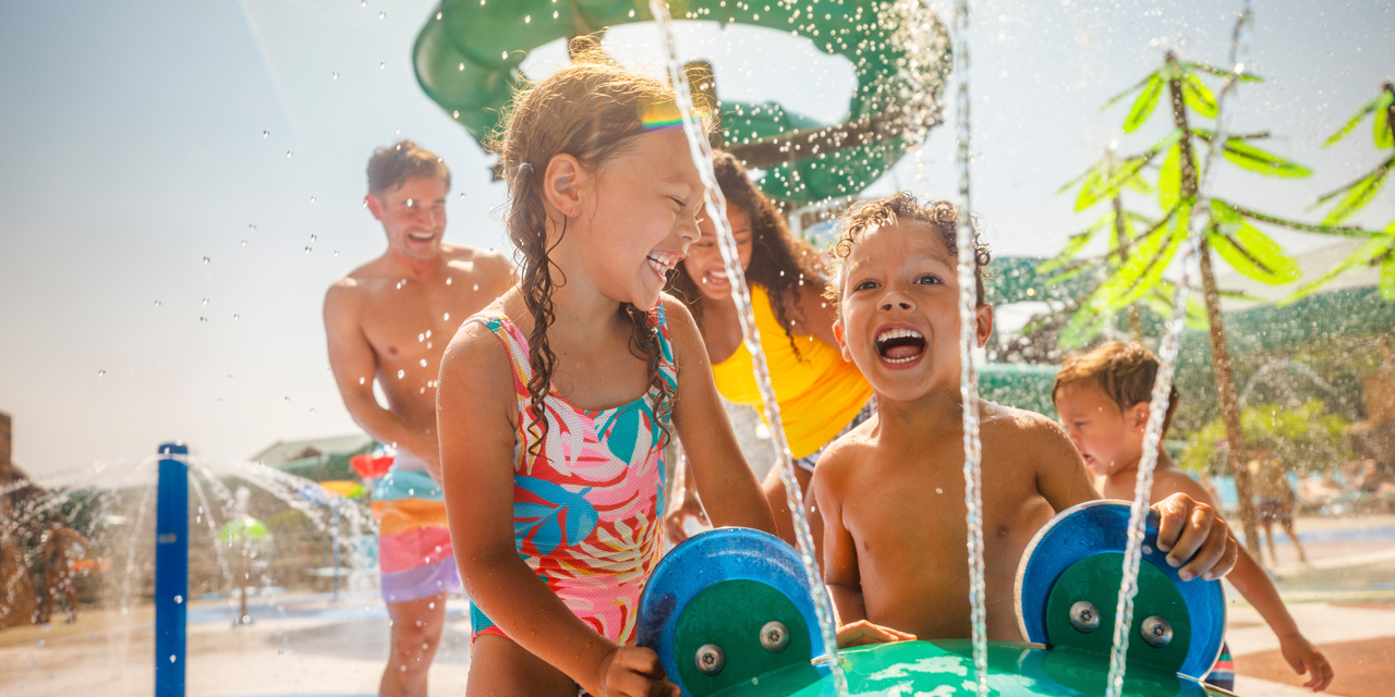 Kids playing at an outdoor waterpark.