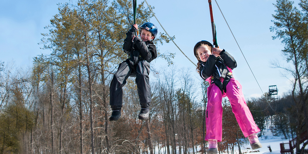 Kids ziplining at BigFoot Ziplines.