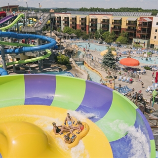 Four people in a tube on a waterslide at Kalahari outdoor waterpark in Wisconsin Dells.