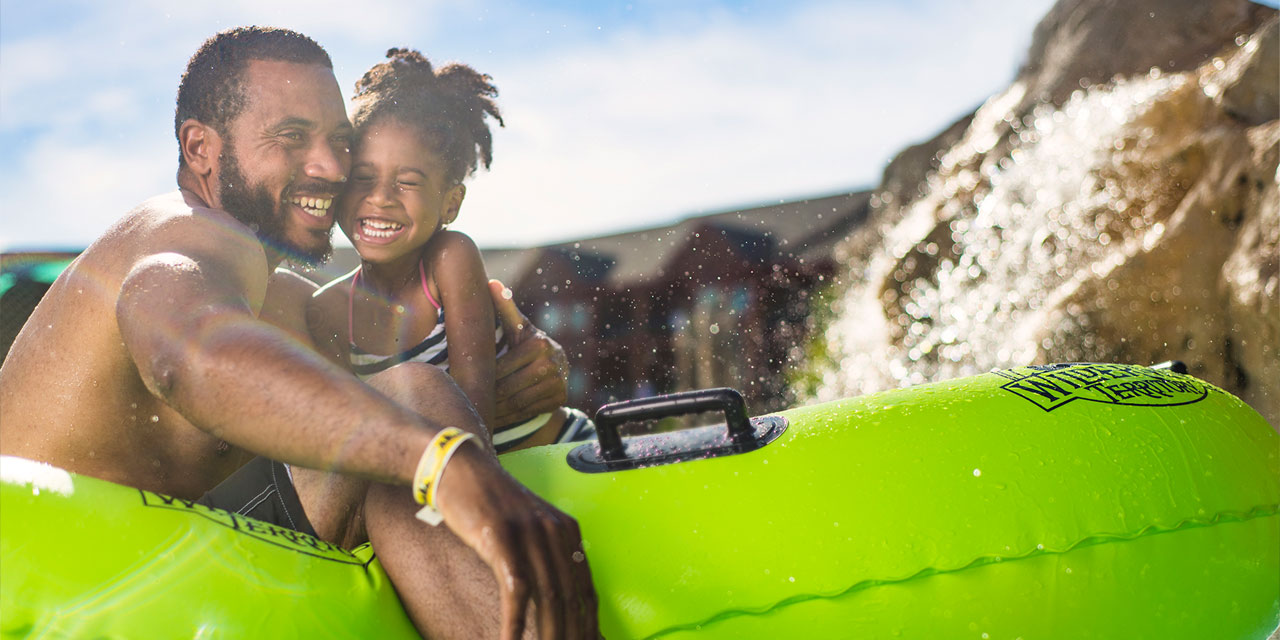 Dad and daughter at outdoor waterpark