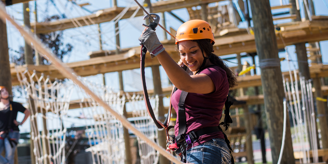 Woman climbing at Bigfoot Ropes Course