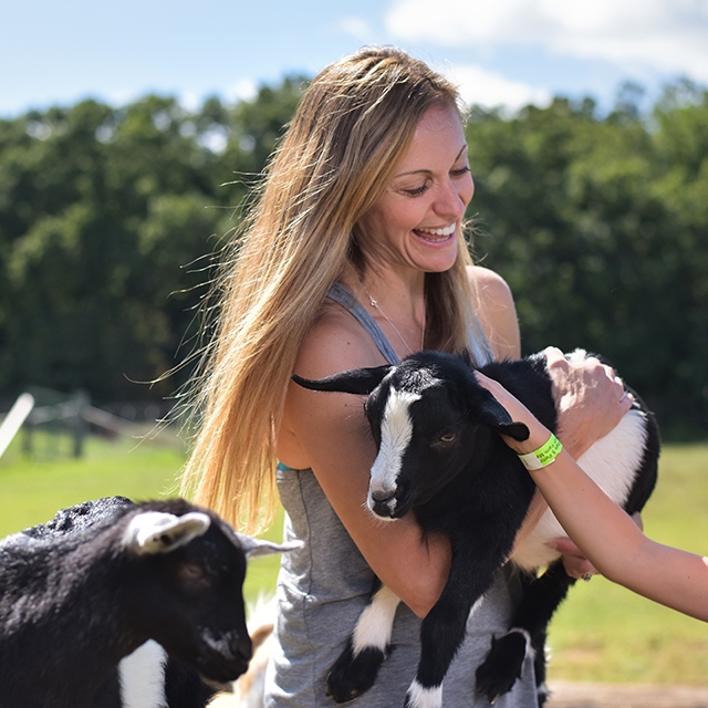 Woman holding a goat at Country Bumpkin.