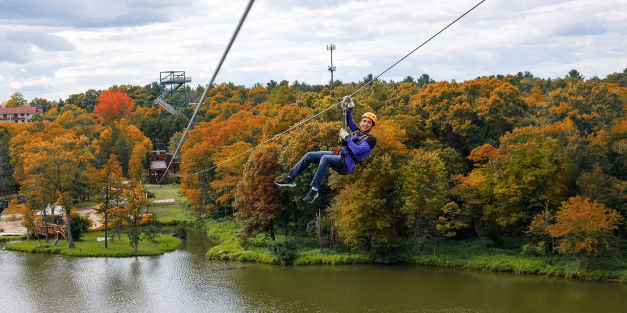 Young man ziplining.