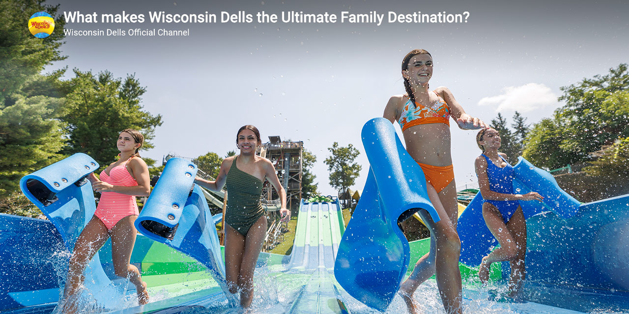 Teenagers in front of a large waterslide.