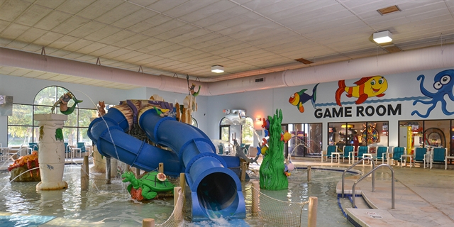 shot of indoor waterpark with game room in background
