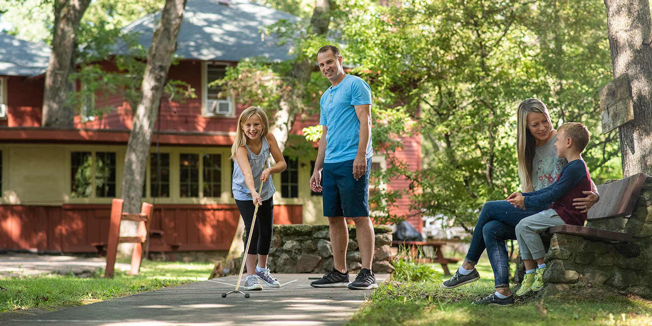 A family playing in an outside game area.